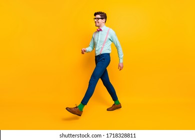 Full Length Profile Photo Of Cool Stylish Guy Boyfriend Walking Down Street Date Girlfriend Wear Specs Shirt Bow Tie Suspenders Trousers Shoes Isolated Vivid Yellow Color Background