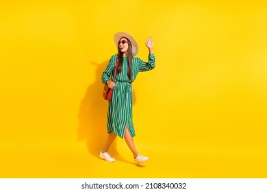 Full Length Profile Photo Of Funny Mature Brunette Lady Go Wave Wear Cap Green Dress Shoes Bag Eyewear Isolated On Yellow Color Background