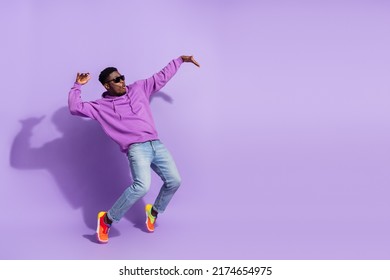 Full length profile photo of overjoyed carefree person stand tip toe dancing isolated on purple color background