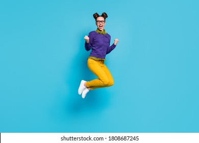 Full length profile photo of pretty crazy lady two buns jump high celebrate college graduating excellent degree diploma wear specs shirt pullover pants isolated blue color background - Shutterstock ID 1808687245
