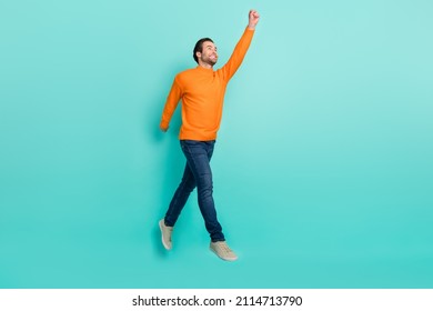 Full Length Profile Portrait Of Cheerful Man Raise Arm Empty Space Hold Imagine Umbrella Isolated On Teal Color Background