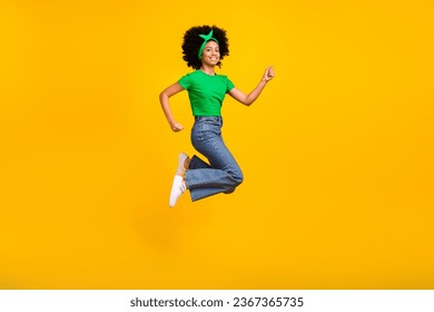 Full length profile portrait of delighted carefree girl jump raise fist success achievement isolated on yellow color background - Shutterstock ID 2367365735