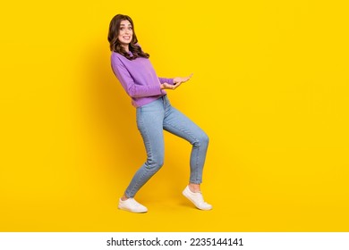 Full length profile portrait of hardworking person arms hold heavy empty space object isolated on yellow color background - Shutterstock ID 2235144141