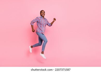 Full length profile portrait of pretty carefree person running jump empty space isolated on pink color background - Shutterstock ID 2207371587