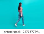 Full length profile portrait of walking young person look empty space isolated on turquoise color background
