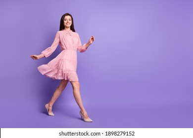 Full length profile portrait of walking girl beaming smile look camera wear vintage isolated on violet color background - Powered by Shutterstock