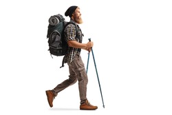 Full Length Profile Shot Of A Bearded Man With A Backpack And Hiking Poles Walking Isolated On White Background