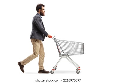 Full length profile shot of a bearded man pushing a shopping cart isolated on white background