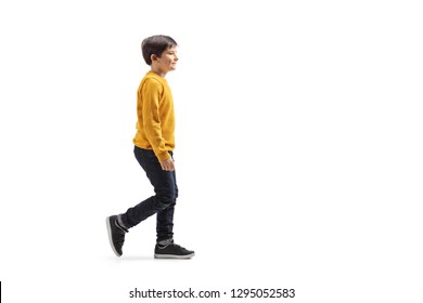 Full Length Profile Shot Of A Boy Walking And Smiling Isolated On White Background