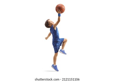 Full length profile shot of a boy in a blue jersey jumping with a basketball isolated on white background