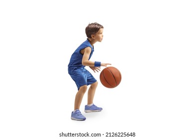 Full length profile shot of a boy in a blue jersey playing basketball isolated on white background - Shutterstock ID 2126225648