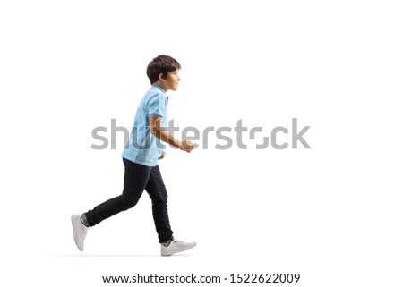 Full length profile shot of a boy in jeans running isolated on white background