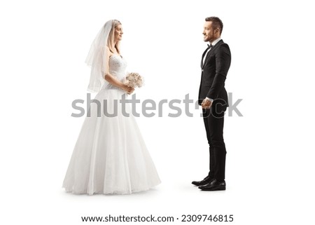 Full length profile shot of a bride looking at a groom isolated on white background