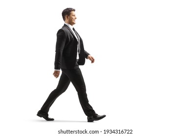 Full length profile shot of a businessman walking isolated on white background - Shutterstock ID 1934316722