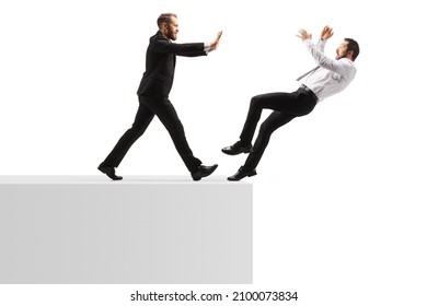Full length profile shot of a businessman pushing a man from a wall isolated on white background