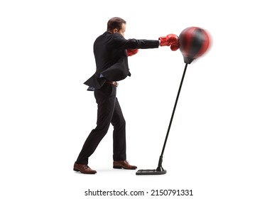 Full Length Profile Shot Of A Businessman Hitting A Free Stand Punch Bag Isolated On White Background