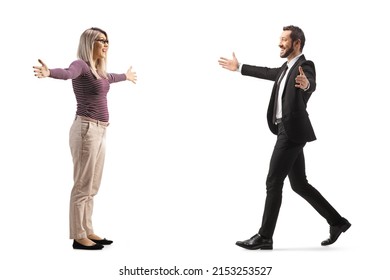 Full length profile shot of a businessman walking towards a young woman with arms wide open isolated on white background