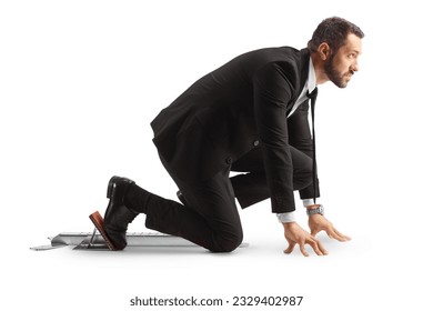 Full length profile shot of a businessman preparing for a run on starting blocks isolated on white background - Powered by Shutterstock