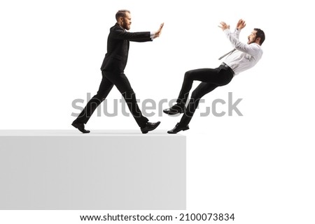 Full length profile shot of a businessman pushing a man from a wall isolated on white background