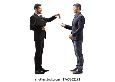 Full length profile shot of a car salesman giving car keys to a man isolated on white background - Powered by Shutterstock