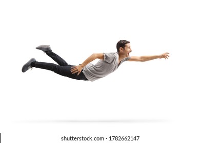 Full length profile shot of a casual young man flying and reaching for something isolated on white background - Shutterstock ID 1782662147