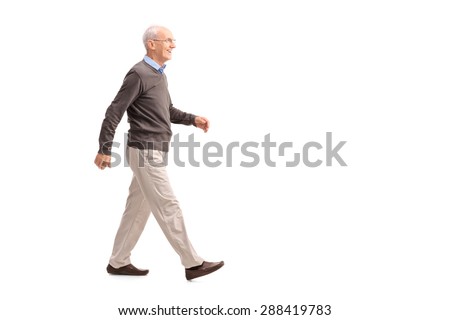 Full length profile shot of a casual senior man walking and smiling isolated on white background