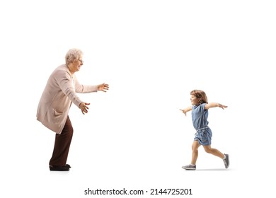 Full Length Profile Shot Of A Child Running Towards Grandmother With Arms Wide Open Isolated On White Background