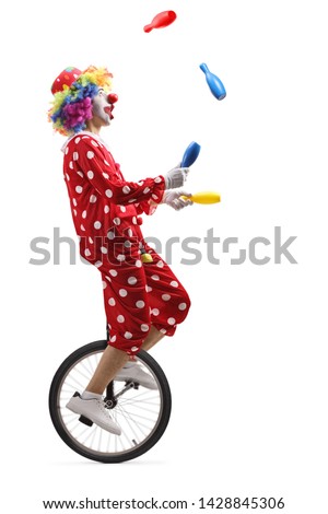 Full length profile shot of a clown on a unicycle juggling with clubs isolated on white background