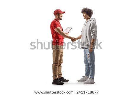 Full length profile shot of a courier shaking hands with a young man isolated on white background