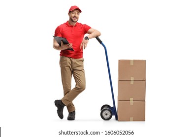 Full length profile shot of a delivery man with cardboard boxes on hand truck isolated on white background