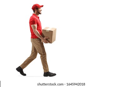 Full length profile shot of a delivery man carrying a package and walking isolated on white background