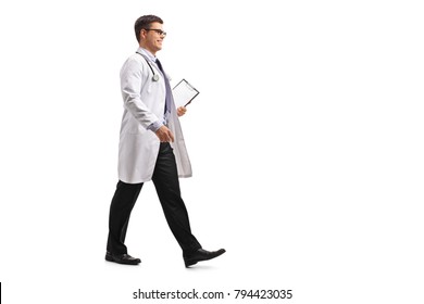 Full length profile shot of a doctor with a clipboard walking isolated on white background - Powered by Shutterstock