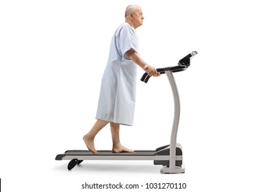 Full Length Profile Shot Of An Elderly Patient Walking On A Treadmill Isolated On White Background