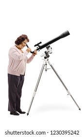 Full Length Profile Shot Of An Elderly Woman Looking Through A Telescope Isolated On White Background