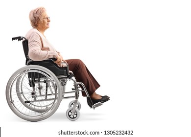 Full Length Profile Shot Of An Elderly Disabled Woman Sitting In A Wheelchair Isolated On White Background