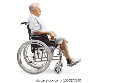 Full Length Profile Shot Of An Elderly Male Patient In A Hospital Gown Sitting In A Wheelchair Isolated On White Background