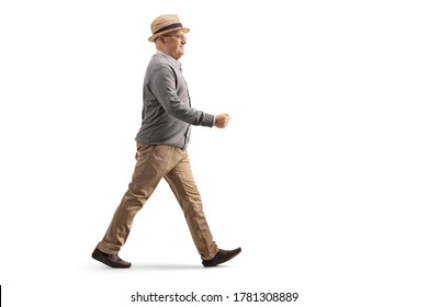 Full Length Profile Shot Of An Elderly Gentleman Walking Isolated On White Background