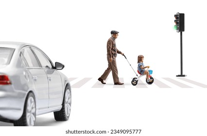 Full length profile shot of an elderly man walking and pushing a girl on a tricycle a street isolated on white background - Powered by Shutterstock