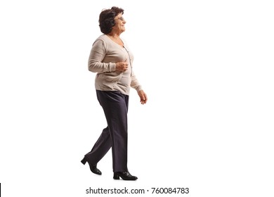 Full length profile shot of an elderly woman walking isolated on white background