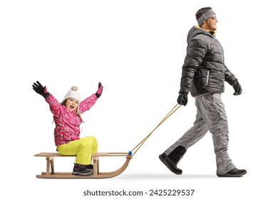 Full length profile shot of a father pulling a happy little girl on a wooden sled isolated on white background - Powered by Shutterstock