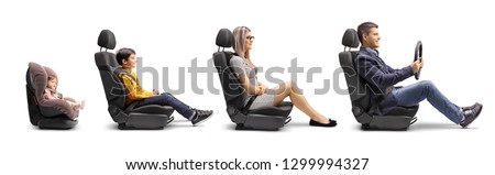 Full length profile shot of a father, mother, boy and baby in car seats with a fastened seat belt simulating a car ride isolated on white background