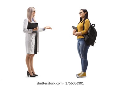 Full Length Profile Shot Of A Female Doctor Talking To A Female Student Isolated On White Background