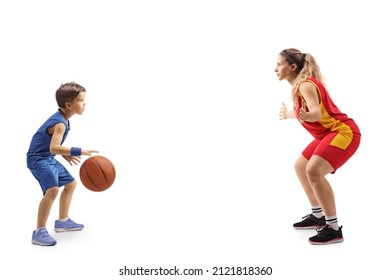 Full length profile shot of a female basketball coach and a little boy playing basketball isolated on white background