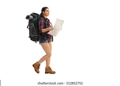 Full Length Profile Shot Of A Female Hiker Walking And Holding A Generic Map Isolated On White Background