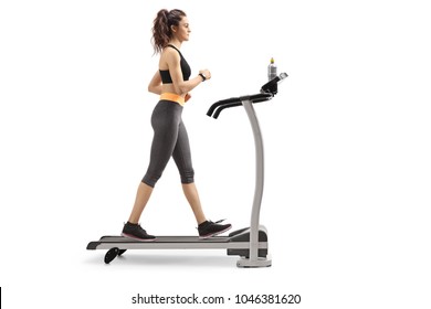 Full Length Profile Shot Of A Fitness Woman Walking On A Treadmill Isolated On White Background