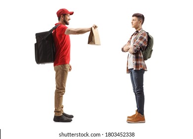 Full Length Profile Shot Of A Food Delivery Guy Delivering A Paper Bag To A Student Isolated On White Background