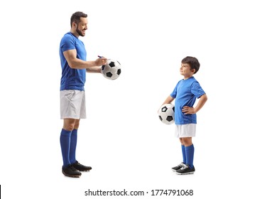 Full Length Profile Shot Of A Footballer Signing An Autograph On A Soccer Ball For A Junior Football Player Isolated On White Background