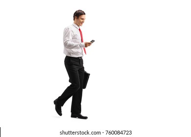 Full Length Profile Shot Of A Formally Dressed Guy With A Briefcase Using A Phone And Walking Isolated On White Background