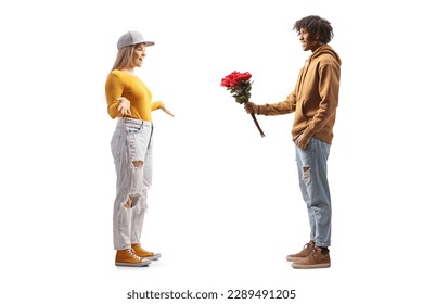 Full length profile shot of a gen z african american man giving a bunch of roses to a caucasian girl isolated on white background - Powered by Shutterstock