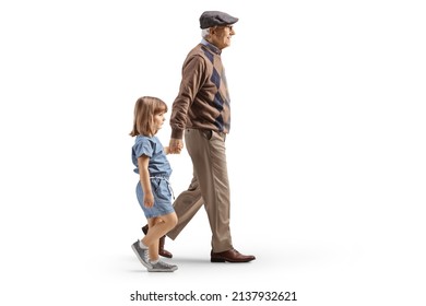 Full length profile shot of a grandfather and granddaughter walking and holding hands isolated on white background